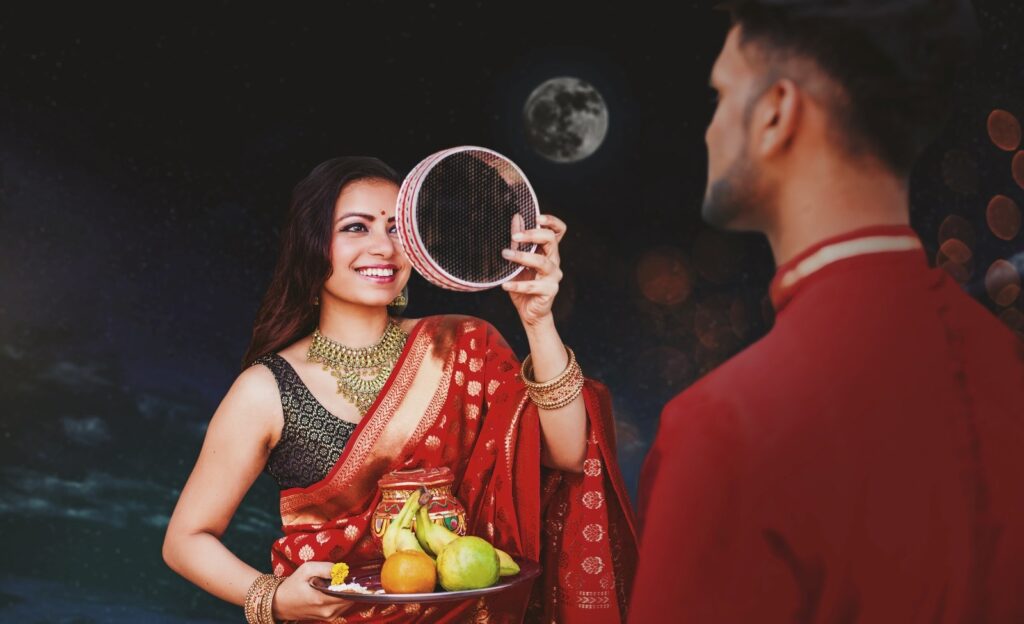 Woman looking at her husband through a sieve on Karwa Chauth